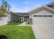 Thumbnail 17 of 39 - A modern house with a grey garage door.