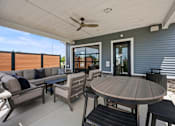 Thumbnail 35 of 39 - A patio with a table and chairs is shown.