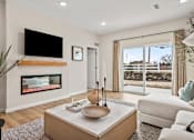 Thumbnail 4 of 39 - A modern living room with a fireplace and a flat screen TV mounted above it.