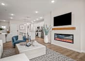 Thumbnail 5 of 39 - A modern living room with a fireplace and a flat screen TV mounted on the wall.
