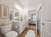 Thumbnail 9 of 39 - A white bathroom with a toilet, sink, and mirror.