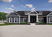Thumbnail 12 of 19 - A large house with a driveway in front.