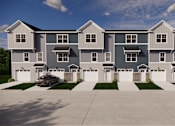 Thumbnail 2 of 15 - A large, modern house with a grey and white exterior and a car parked in the driveway.