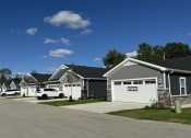 Thumbnail 40 of 43 - a row of houses with cars parked in front of them