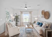 Thumbnail 1 of 17 - a living room with couches and chairs and a ceiling fan