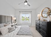 Thumbnail 7 of 17 - a bedroom with a large bed and a ceiling fan