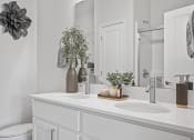 Thumbnail 10 of 17 - a white bathroom with two sinks and a mirror