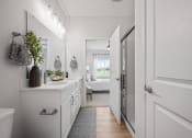 Thumbnail 9 of 17 - a white bathroom with a white counter top and a glass shower