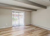 Thumbnail 15 of 27 - A room with wooden flooring and a sliding glass door.