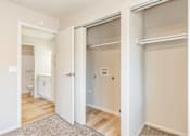 Thumbnail 22 of 27 - A white door is open to a room with a bed and a small table.
