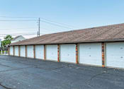 Thumbnail 24 of 27 - A row of white garage doors are closed.
