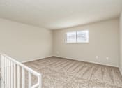Thumbnail 6 of 27 - Empty room with carpeted floor and a window.
