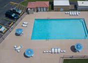 Thumbnail 3 of 13 - Large swimming pool with lounge chairs, tables and umbrellas