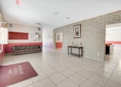 Thumbnail 6 of 10 - A room with a brick wall and a bench.
