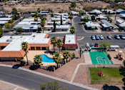 Thumbnail 2 of 10 - A view of a resort with a swimming pool and a basketball court.
