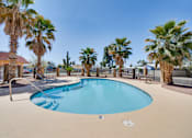 Thumbnail 4 of 10 - A swimming pool surrounded by palm trees.