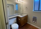 Thumbnail 8 of 11 - a bathroom with a toilet sink and a mirror