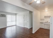 Thumbnail 28 of 28 - an empty living room and kitchen with a ceiling fan
