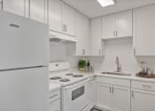 Thumbnail 3 of 28 - a kitchen with white cabinets and white appliances