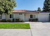 Thumbnail 9 of 15 - a white house with a white garage door and a lawn