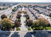 Thumbnail 5 of 15 - an aerial view of a parking lot with cars and trees