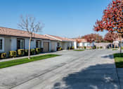 Thumbnail 8 of 15 - a street with houses on the side of a road