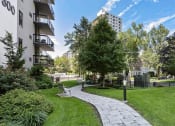 Thumbnail 4 of 26 - Exterior shot of winding pathway on green grass, at Prospect Place, NJ 07601