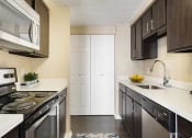 Thumbnail 9 of 26 - Modern kitchen w/ electric stove, dish washer, and granite counter tops at Prospect Place, NJ 07601