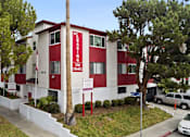 Thumbnail 1 of 9 - A red and white building with the words "LEASING" and "310" on it.