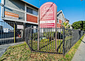 Thumbnail 1 of 23 - A sign for Casa Royale Apartments is displayed in front of a fence.