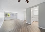 Thumbnail 13 of 23 - A room with wooden flooring and a ceiling fan.