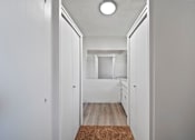 Thumbnail 15 of 21 - A hallway with a brown rug on the floor.