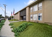 Thumbnail 2 of 8 - A building with the word "COVE" on the side is surrounded by greenery.