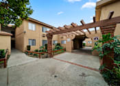 Thumbnail 13 of 23 - A building with a covered walkway and a clear sky.
