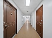 Thumbnail 21 of 23 - A hallway with doors on both sides and a door numbered 146.