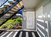 Thumbnail 7 of 7 - A leasing office with a door and a sign on it.