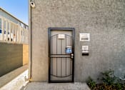 Thumbnail 3 of 5 - A black gate with a blue sign that says "OPEN" in front of a grey wall.