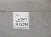 Thumbnail 5 of 5 - A sign for Glen Terrace Apartments is on a wall.