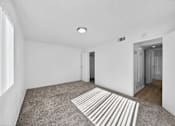 Thumbnail 9 of 20 - A room with a striped rug on the floor.