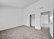 Thumbnail 7 of 20 - A room with a grey carpet and white walls.