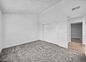 Thumbnail 6 of 20 - A room with a grey carpet and white walls.