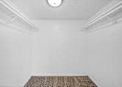 Thumbnail 18 of 20 - A room with a white ceiling and a brown carpet.