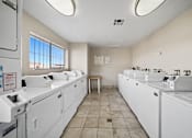 Thumbnail 13 of 13 - A laundromat with washers and dryers is shown.