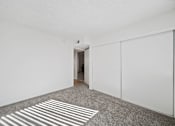 Thumbnail 8 of 13 - A room with a carpet and a white wall.