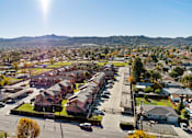 Thumbnail 2 of 13 - A sunny day in a residential area with houses and trees.