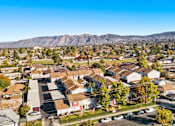 Thumbnail 3 of 12 - A residential area with houses and cars under a clear sky.