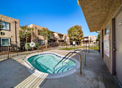 Thumbnail 4 of 5 - A small pool in a courtyard surrounded by buildings.