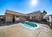 Thumbnail 3 of 5 - A sunny day at the pool area of a residential complex.