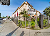 Thumbnail 2 of 19 - A sign for North Hills Village with a phone number is displayed on a fence.