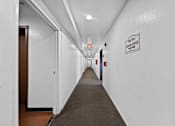 Thumbnail 9 of 10 - A long hallway with a sign that says "Lobby Office".